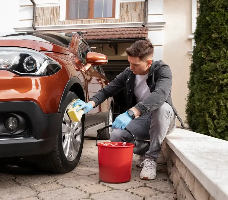 Lavage auto à domicile Besneville : professionnel intervenant sur un véhicule